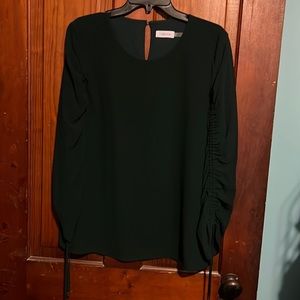 Dark green Calvin Klein shirt. Almost Positive it’s a large but the size tag